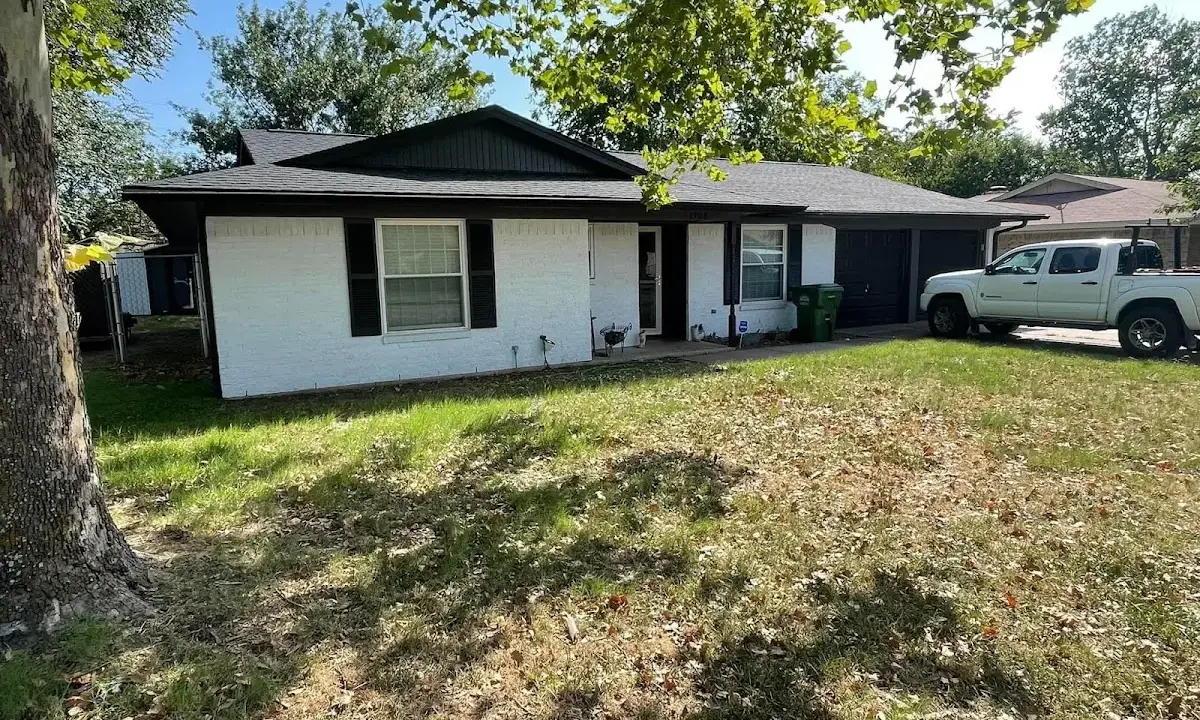 Professional roofing crew working on a residential roof in Corbin